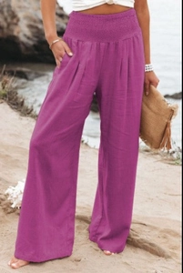 Detail of smocked high waist and side pocket on purple wide leg linen trousers
