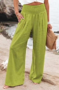 Detailed view of the green smocked waist and side pockets on high waist wide leg pants