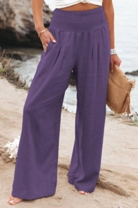 Detail of high waisted purple palazzo pants showing smocked elastic waistband and side pockets