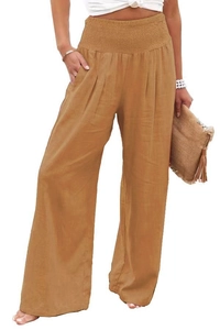 Detail of high waisted wide leg trousers showing natural cotton linen fabric texture