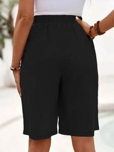 Close-up back view of black linen bermuda shorts with comfortable elastic waistband