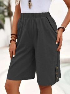Detail of dark grey cotton linen shorts showing side wood button accents and high waist