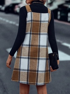 Streetstyle-Ansicht eines Damen-Plaid-Trägerkleids mit schwarzem Rollkragenpullover-Rücken