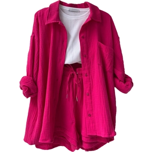 Detailed view of rose red three-piece lounge set with textured long sleeve shirt and shorts
