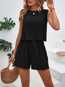 Detail of black sleeveless top and drawstring shorts set with woven fabric texture