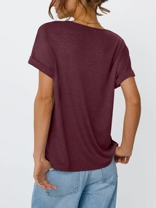 Detailed back view of a loose wine red T-shirt featuring rolled cuffs and textured fabric