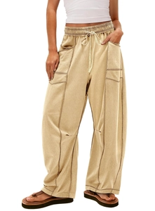 Detail view of khaki wide-leg cargo pants featuring drawstring waist and contrast stitching