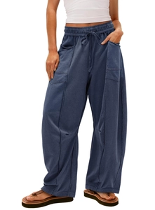 Detail of loose-fit drawstring waistband and utility cargo pockets on navy wide-leg pants