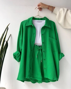 Detail of green crinkle texture shirt with matching drawstring shorts and white ribbed top