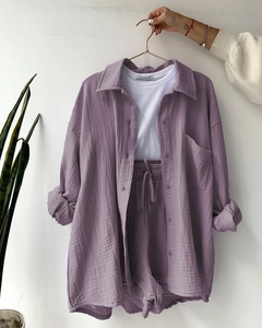 Detail of light purple crinkle fabric texture on casual shirt and drawstring shorts