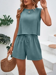 Detail of teal sleeveless top and drawstring shorts in textured waffle knit fabric