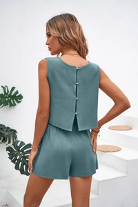 Detail view of summer two-piece set featuring back button closure and linen texture fabric