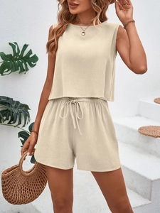 Detail of beige summer set showing textured waffle fabric on sleeveless top and drawstring shorts