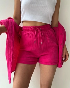 Detailed texture of rose red crinkle fabric on high waisted drawstring shorts and shirt