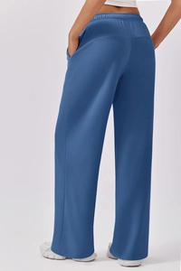 Rear view of dark blue wide-leg sweatpants featuring high waist and loose fit design