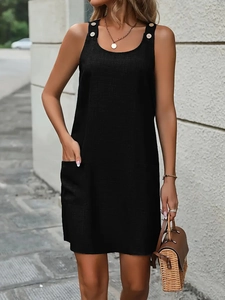 Detail shot of the cotton linen texture, white button accents, and side pockets on a dress