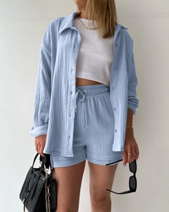 Detail of light blue textured fabric on long sleeve shirt and drawstring shorts