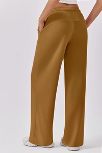 Rear view of high waist wide leg lounge pants in ginger brown with elastic waistband
