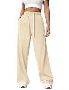 Detail of high waisted wide leg joggers in beige with white drawstring and pockets