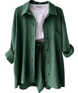 Close-up detail of dark green crinkle fabric textures on casual long sleeve shirt and shorts