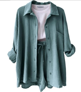 Detailed view of women's 3-piece set featuring textured dark green shirt and drawstring shorts