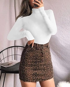 Detail view of slim fit white long sleeve bodysuit paired with a trendy leopard print skirt