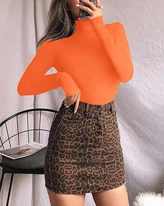 Detail of slim fit orange long sleeve mock neck bodysuit with leopard denim skirt