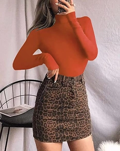 Detail of orange high-neck bodysuit paired with a leopard print mini skirt in a mirror selfie