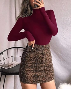 Detail of slim fit wine red long sleeve bodysuit featuring high neck and soft cotton texture