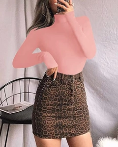 Close-up of pink slim-fit crew neck bodysuit paired with leopard print denim skirt