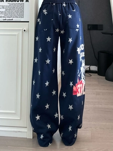 Dettaglio dei pantaloni sportivi blu con stelle bianche e stampa grafica vintage I Love NY