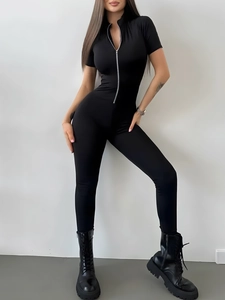 Front view of slim fit black yoga jumpsuit with short sleeves and silver front zipper