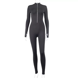 Close-up of black long sleeve slimming jumpsuit featuring a functional metal front zipper