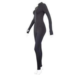 Detail view of black slim fit catsuit featuring high collar, front zipper and thumb holes