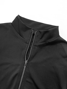 Detailed view of the zip-up collar and stitching on this black athletic slim jumpsuit
