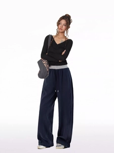 Detail of grey wide-leg lounge pants with drawstring waist and contrast stitching