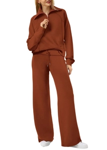 Dettaglio della tuta sportiva rosso ruggine con top a mezza zip e pantaloni larghi a coulisse