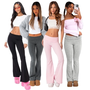 Close-up of high-waist yoga flare pants showing black, grey, and pink color options