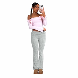 Detail of grey high-waisted flare trousers with fold-over waistband and soft knit fabric
