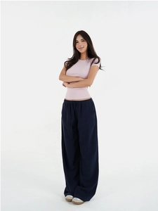 Slim fit light pink crew neck T-shirt paired with dark blue drawstring wide leg pants
