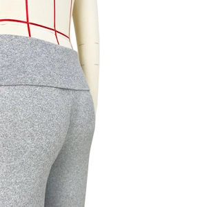 Close-up of the high waist and hips of grey knit yoga pants with fine texture details