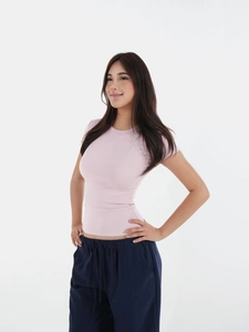 Detail of light pink slim fit short sleeve t-shirt with crew neck and ribbed texture