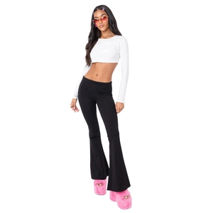 Full body view of women's y2k style black low waist flare pants and white long sleeve top
