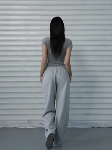 Back view of a grey slim fit short sleeve T-shirt and loose sports trousers set