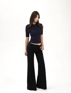 Detail of slim fit navy short sleeve T-shirt paired with high waist flared trousers