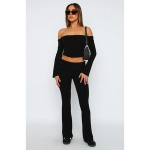 Black two-piece set featuring off-shoulder long sleeve top and flared athletic pants