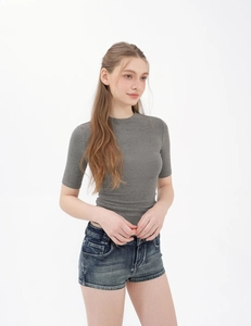 Detail of grey slim-fit knit top paired with classic blue washed denim shorts