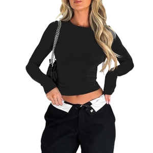 Detail of slim fit black long sleeve crew neck T-shirt paired with fold-over waist trousers