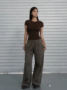 Brown slim fit short sleeve t-shirt paired with grey wide leg drawstring joggers