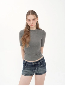 Detail view of grey slim fit ribbed t-shirt paired with denim shorts on white background